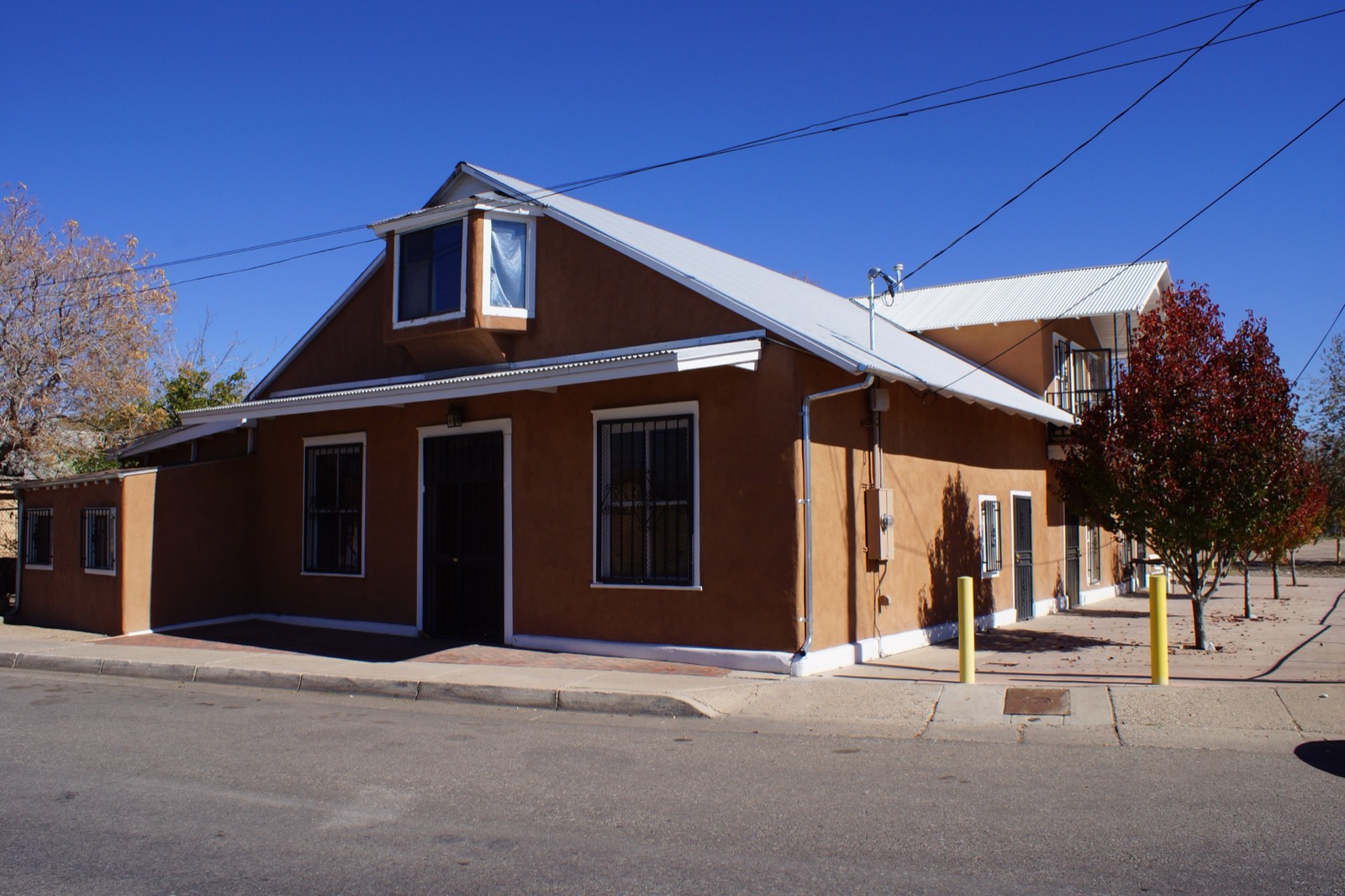 An adobe home in Albuquerque's historic Barelas neighborhood, lit by late-afternoon sun.