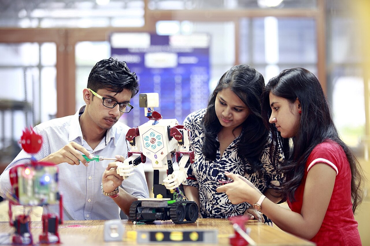 Students building and testing a robotics project in a classroom lab.
