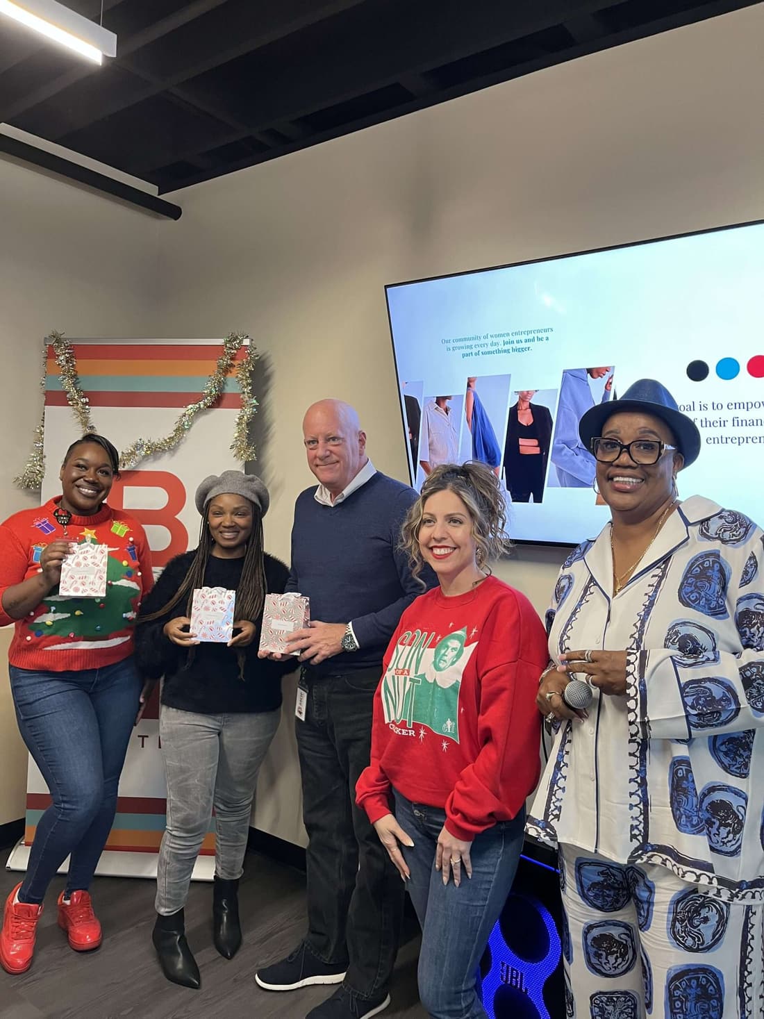Time for Change Foundation and BBOP Center staff together at a holiday gathering, gift bags in hand