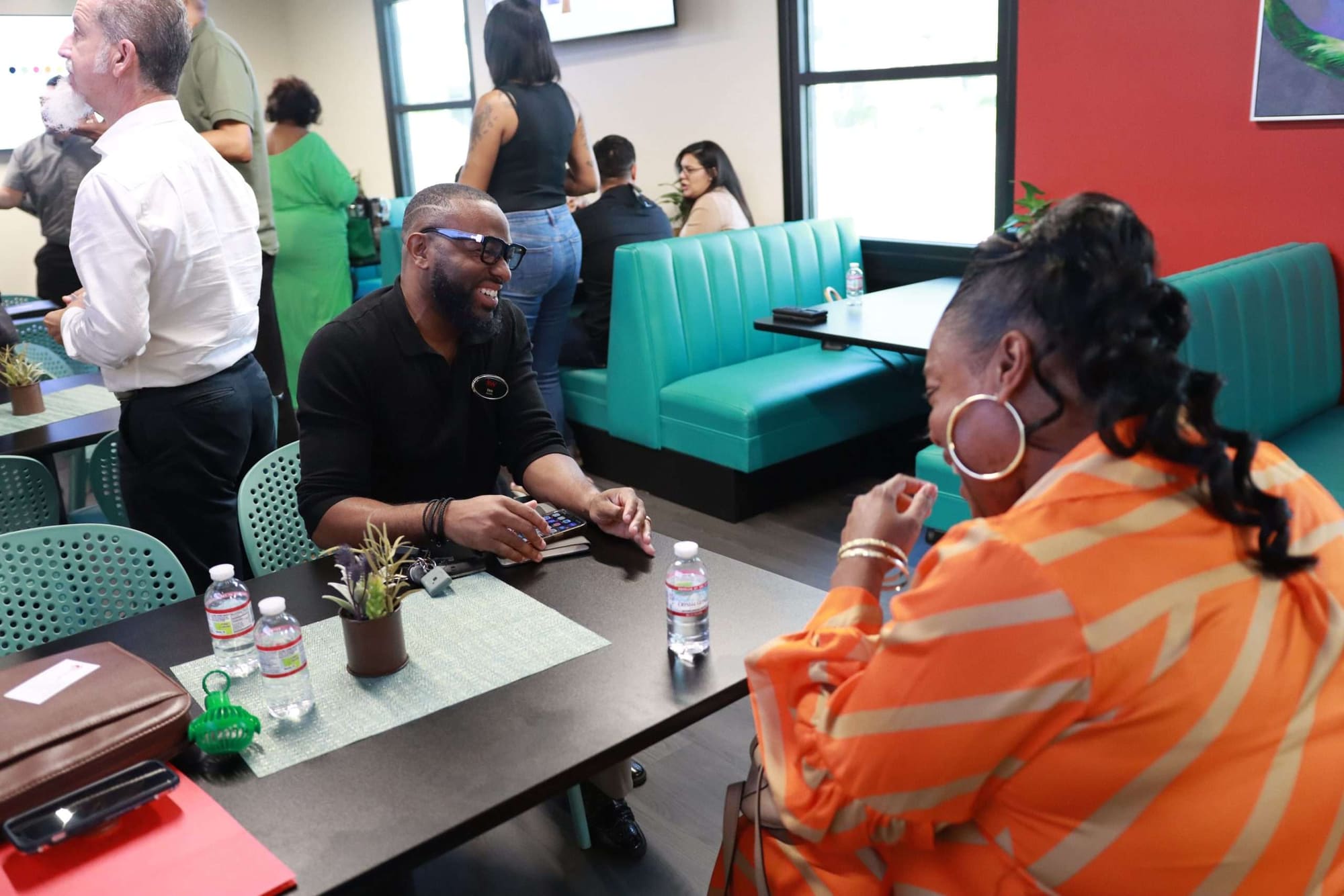 Attendees talking at the tables in the BBOP Center during a Kinetic AI Hub session