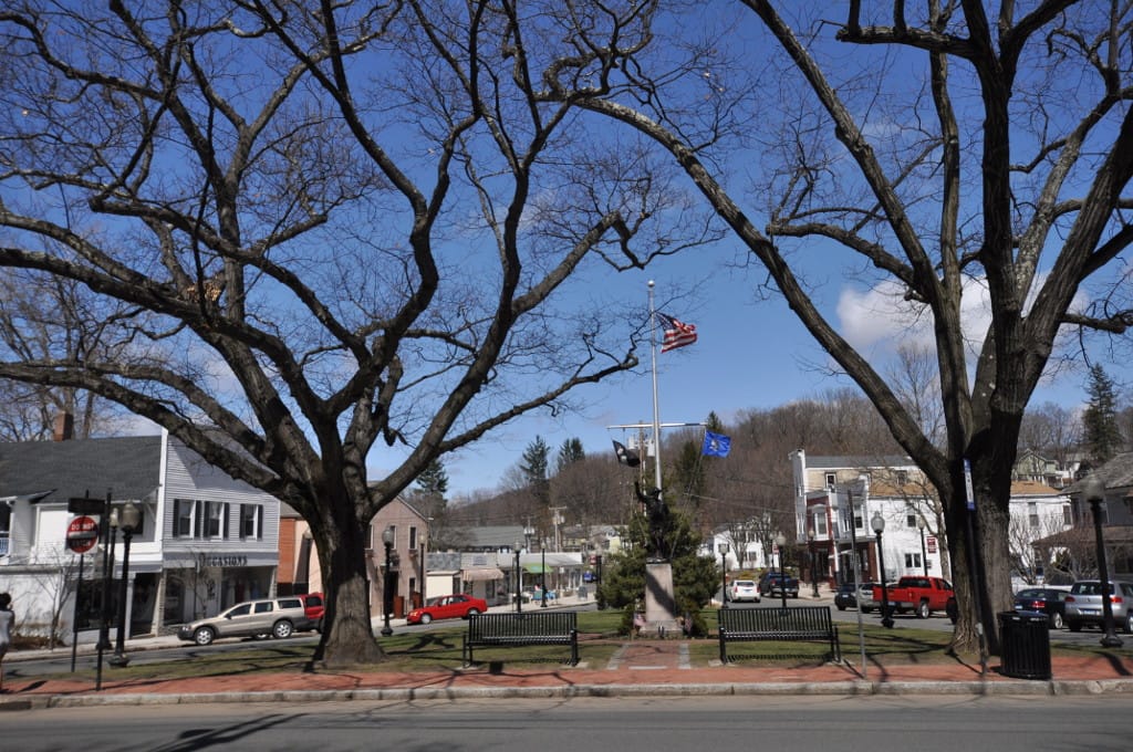 P.T. Barnum Square, a small triangular park with paved paths, benches and mature trees
