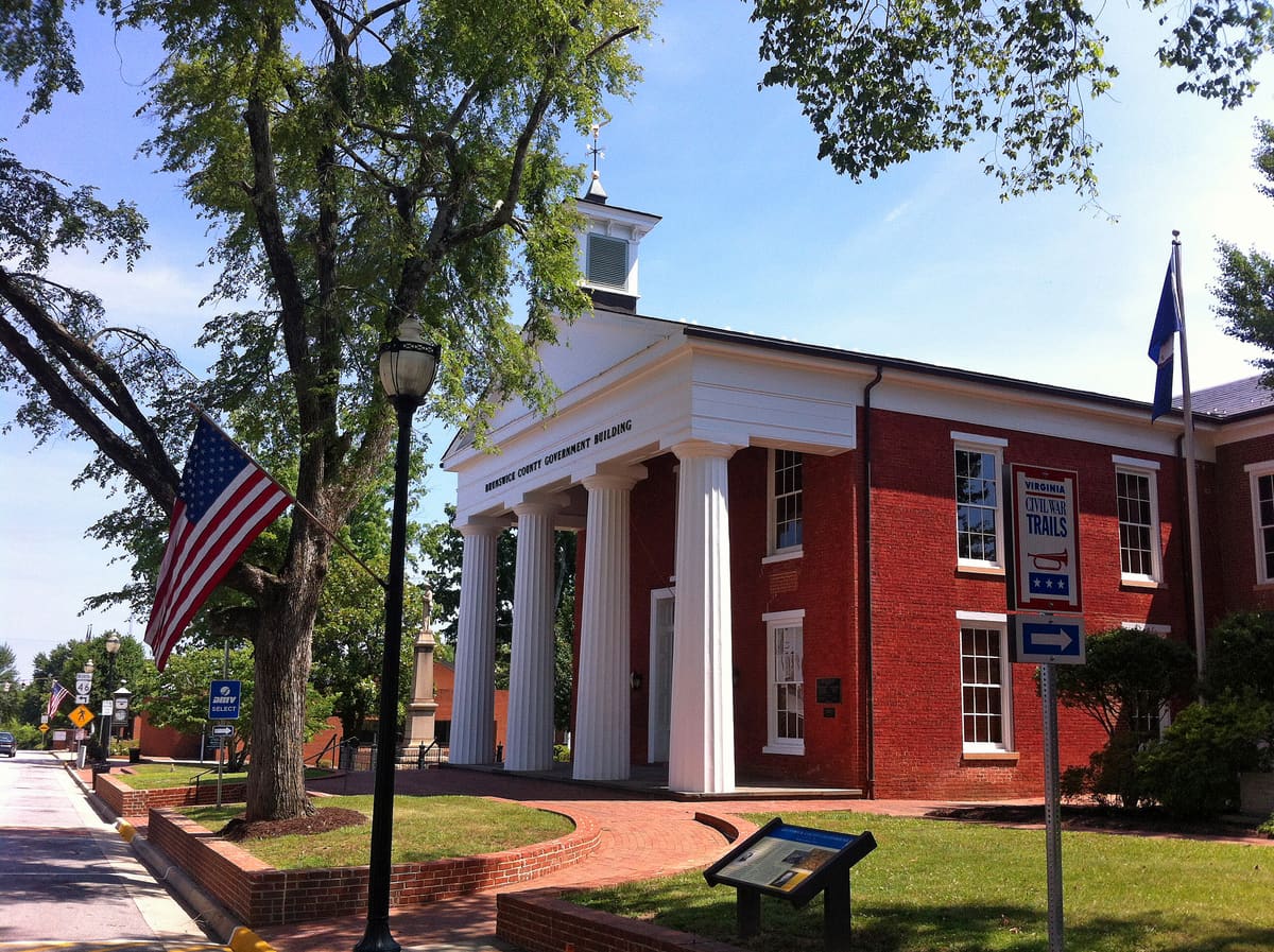 The brick Brunswick County Government Building at 228 North Main Street under a blue sky