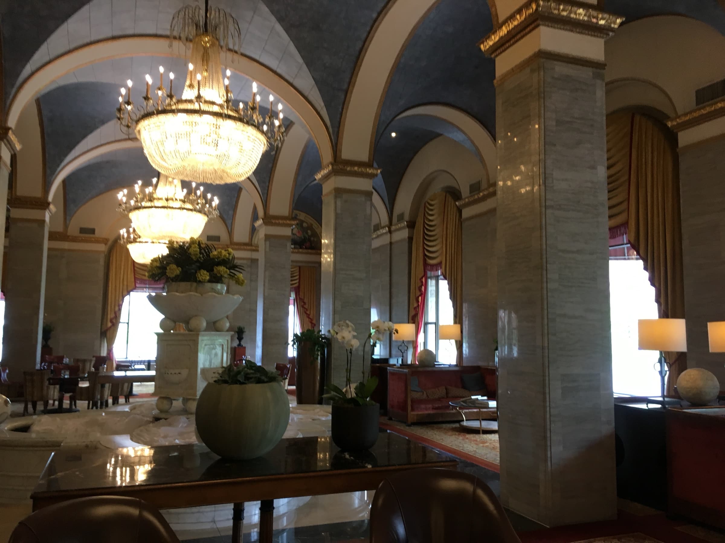 Grand lobby of the Hotel Cleveland (then the Renaissance Cleveland Hotel) with vaulted painted ceilings, crystal chandeliers and marble columns.