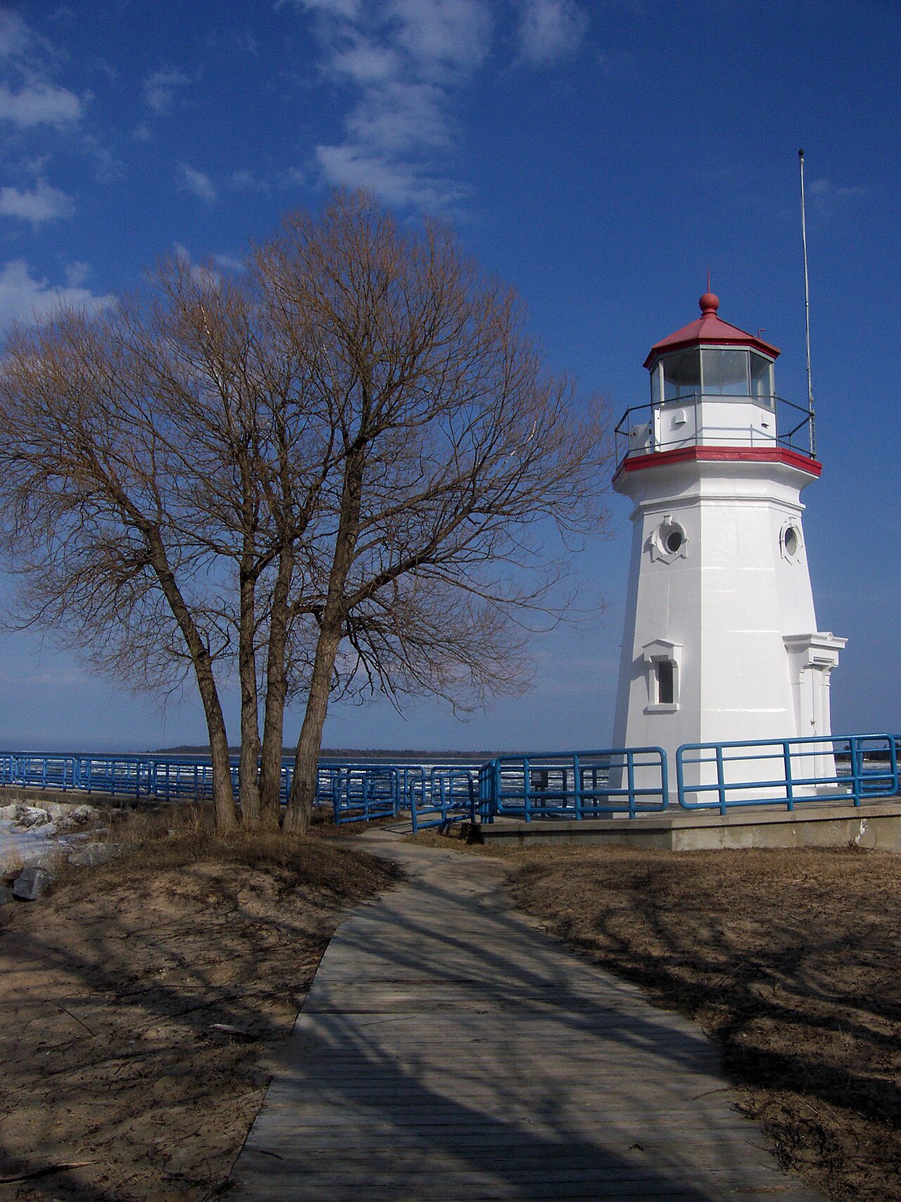 The Cheboygan Crib Light, a small white lighthouse with a red lantern roof on the Lake Huron pier at the mouth of the Cheboygan River.