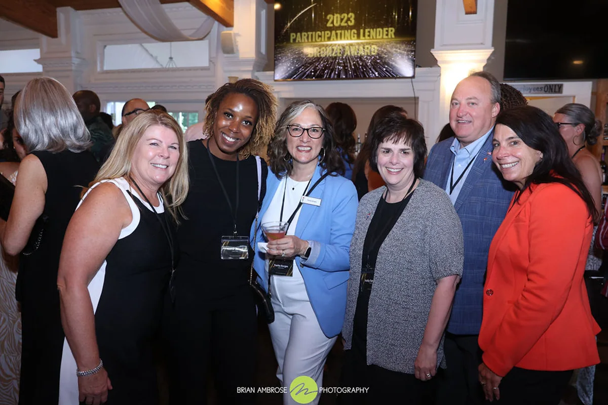 CHFA staff standing with the Liberty Bank team as they receive a Participating Lender Award.