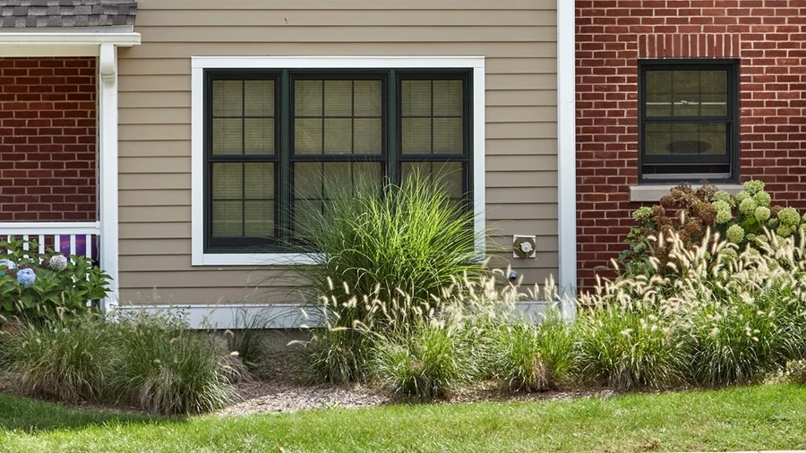 A CHFA-financed two-family at Victory Gardens in Newington, with front porches and planted beds.