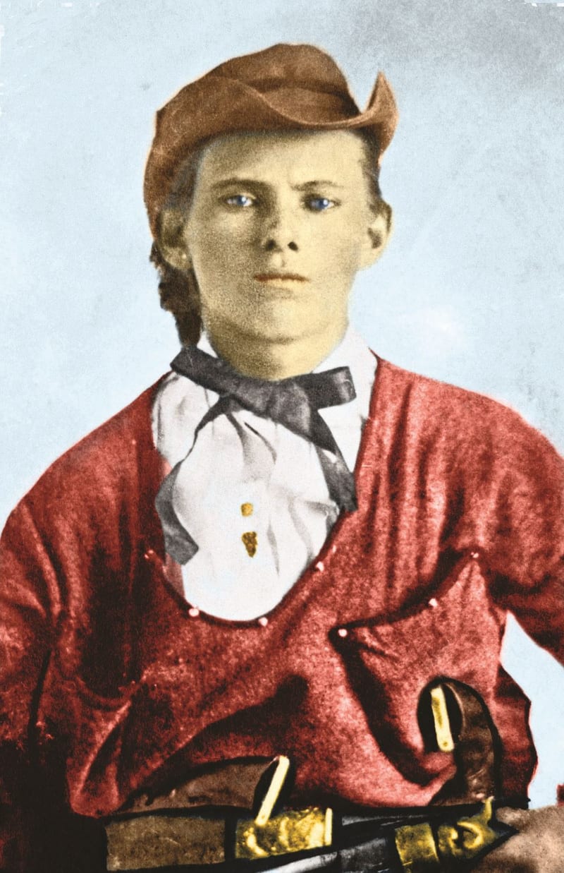 A hand-tinted portrait of a young Jesse James in a red shirt.