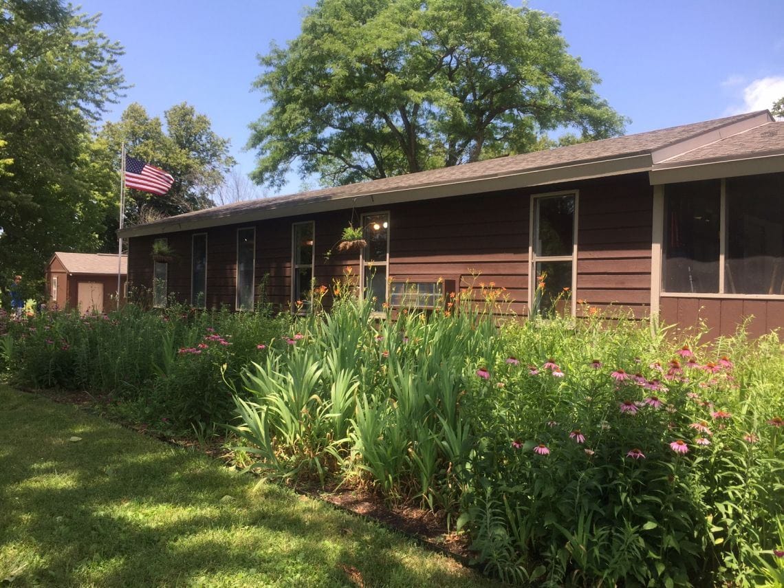 The Nature Center building behind a bed of native wildflowers.