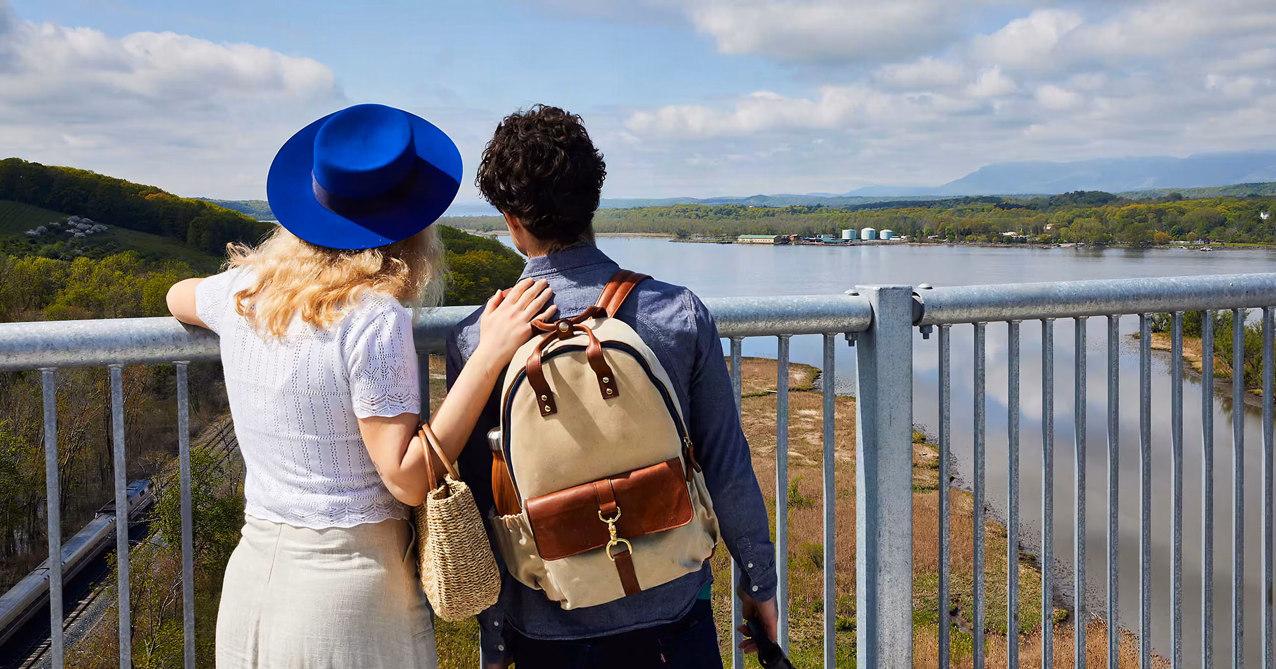 Two visitors on the Rip Van Winkle Bridge, looking out over the Hudson River toward the Catskills