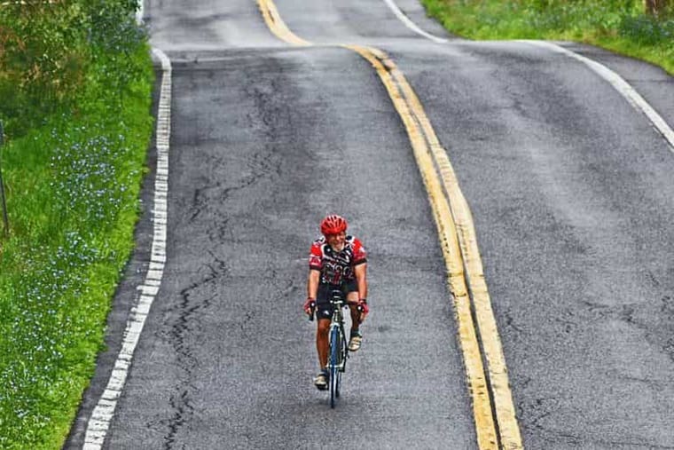 A cyclist on a winding country road in Columbia County