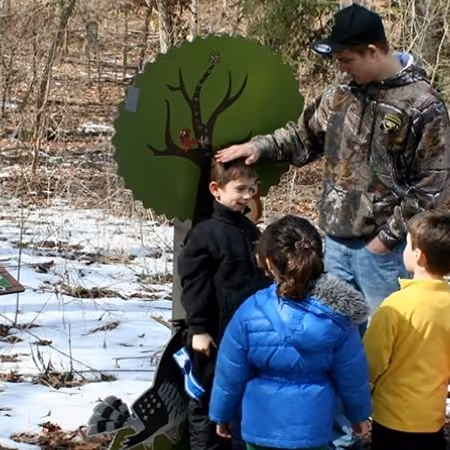 Children and a naturalist on Owlexander's Hoot Route nature literature trail at Grant Park