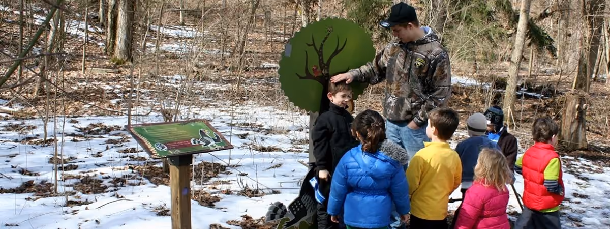 Children and a naturalist on Owlexander's Hoot Route nature literature trail at Grant Park