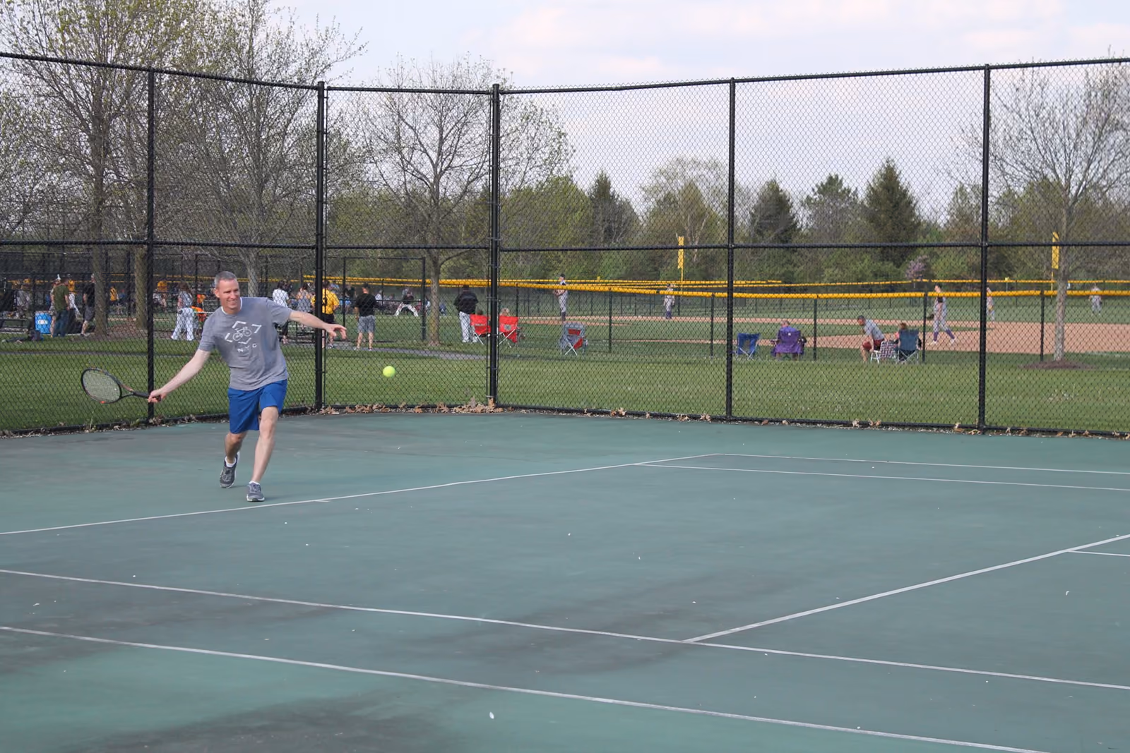 A tennis player serving at Forest Field Park