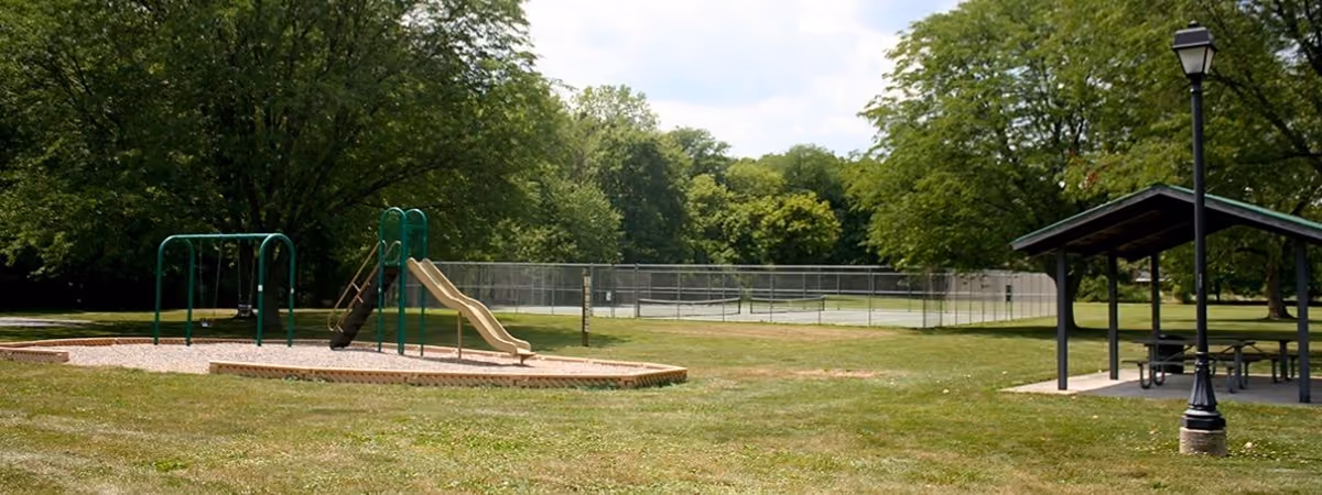 Swings, a slide and a shelter at Village South Park