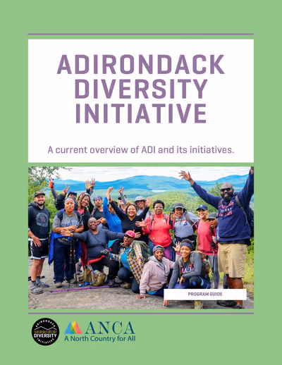 Cover of the 2026 Communication Booklet: a group of ADI participants cheering on a mountain summit