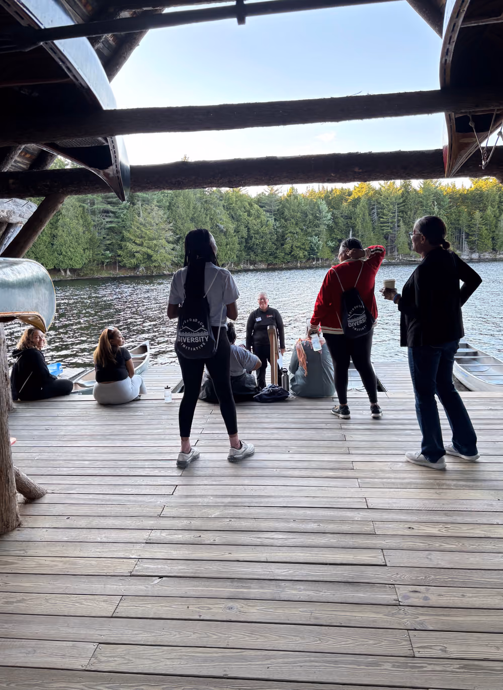 Participants on the boathouse dock over the water
