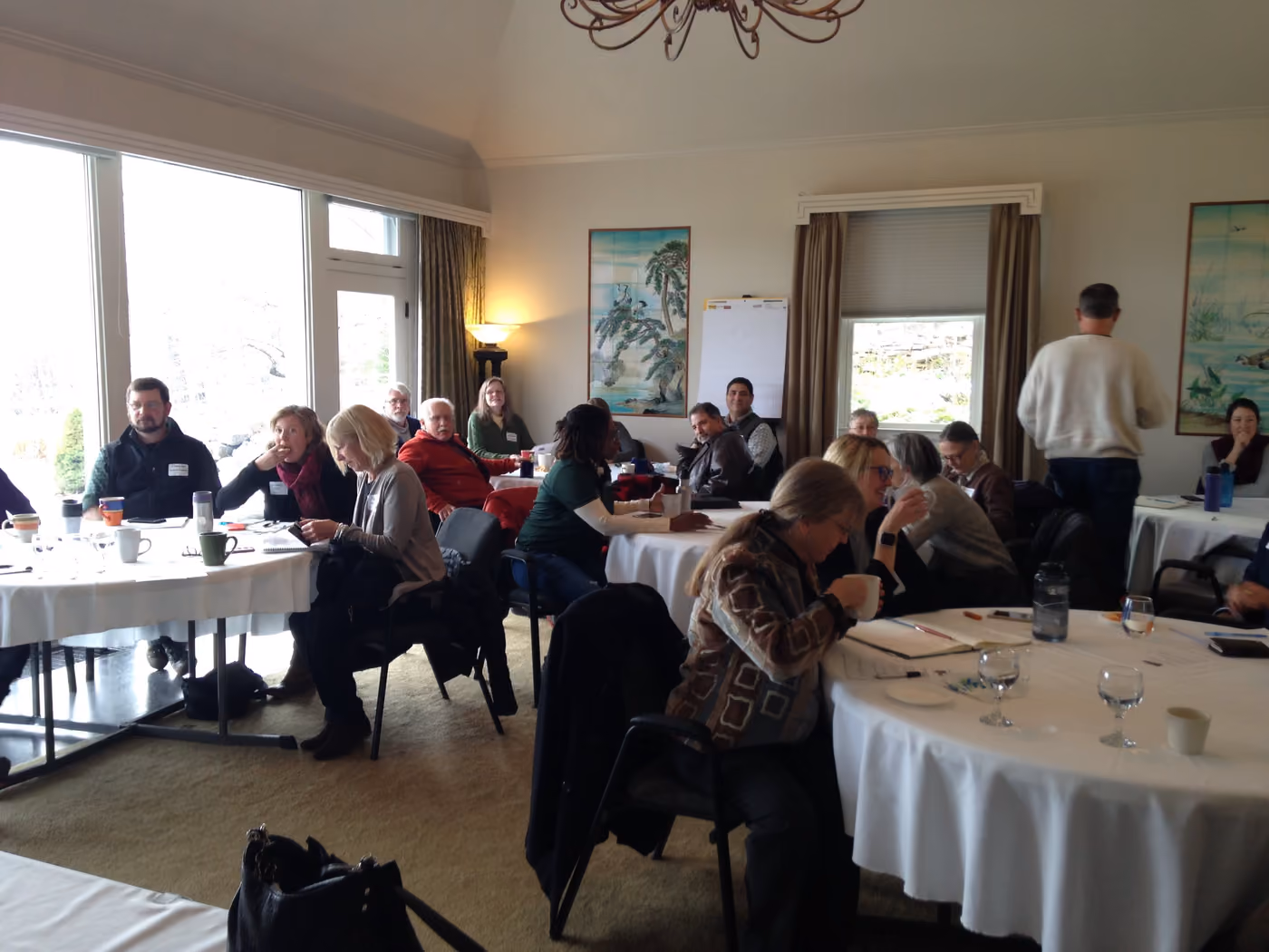 Round tables of attendees in discussion at an earlier ADI gathering