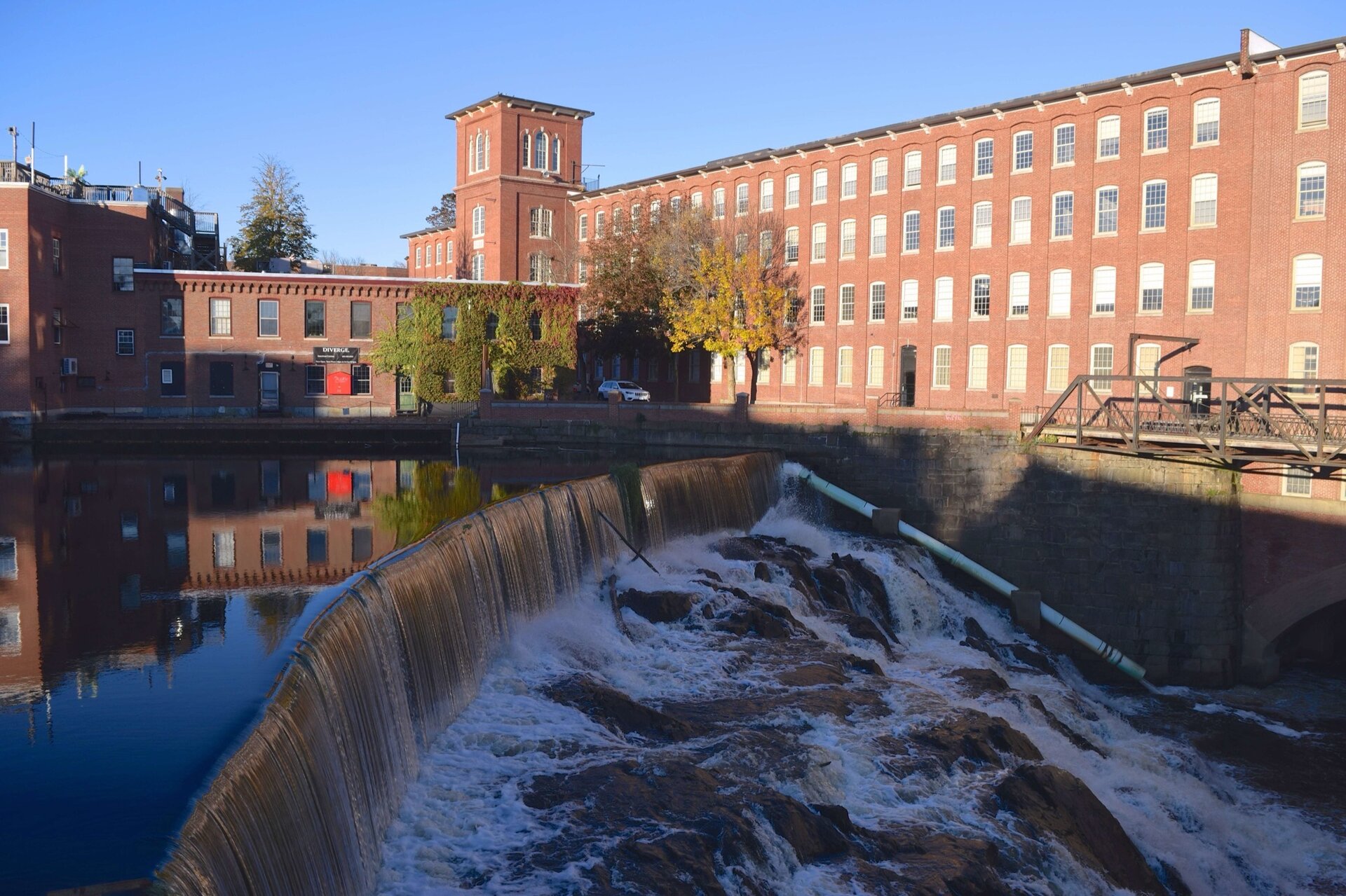 The Cocheco River falls over the dam below Dover's red-brick Cocheco Mill in autumn