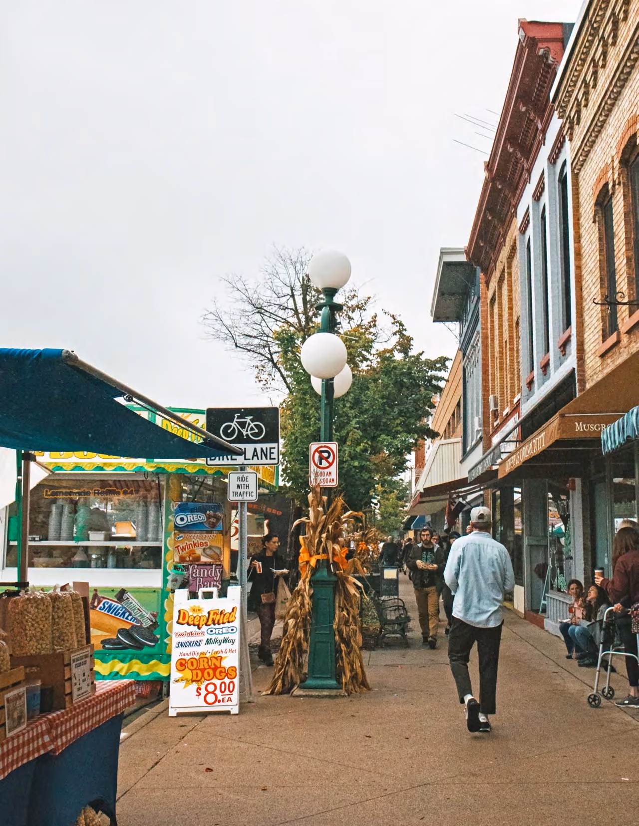 A shopper walking past storefront displays downtown