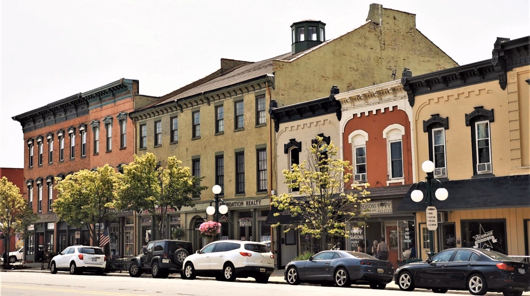 The row of 19th-century brick storefronts on Chicago Boulevard in summer