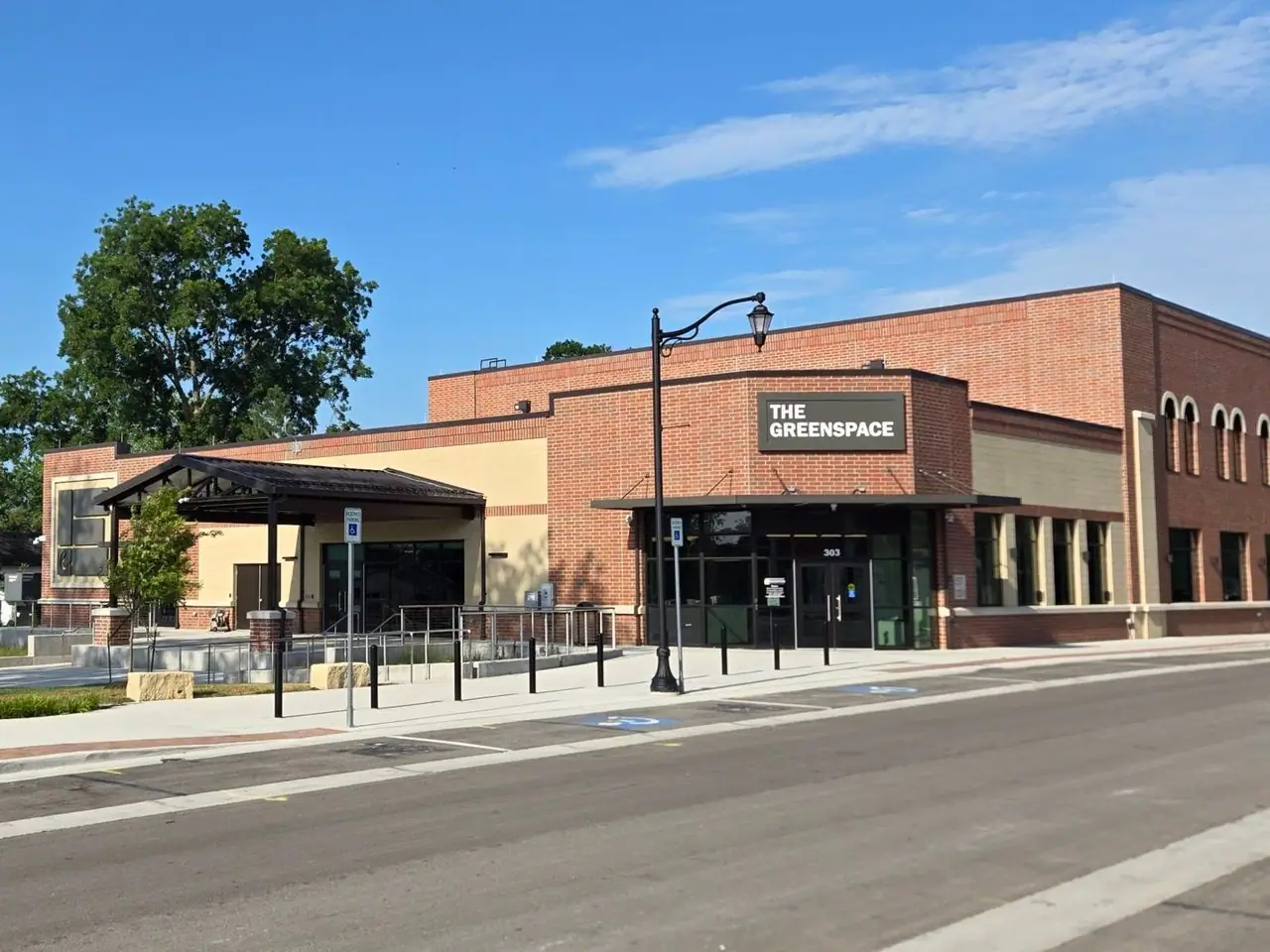 The Greenspace on Nelson Street, a brick building with its name above the corner entrance.