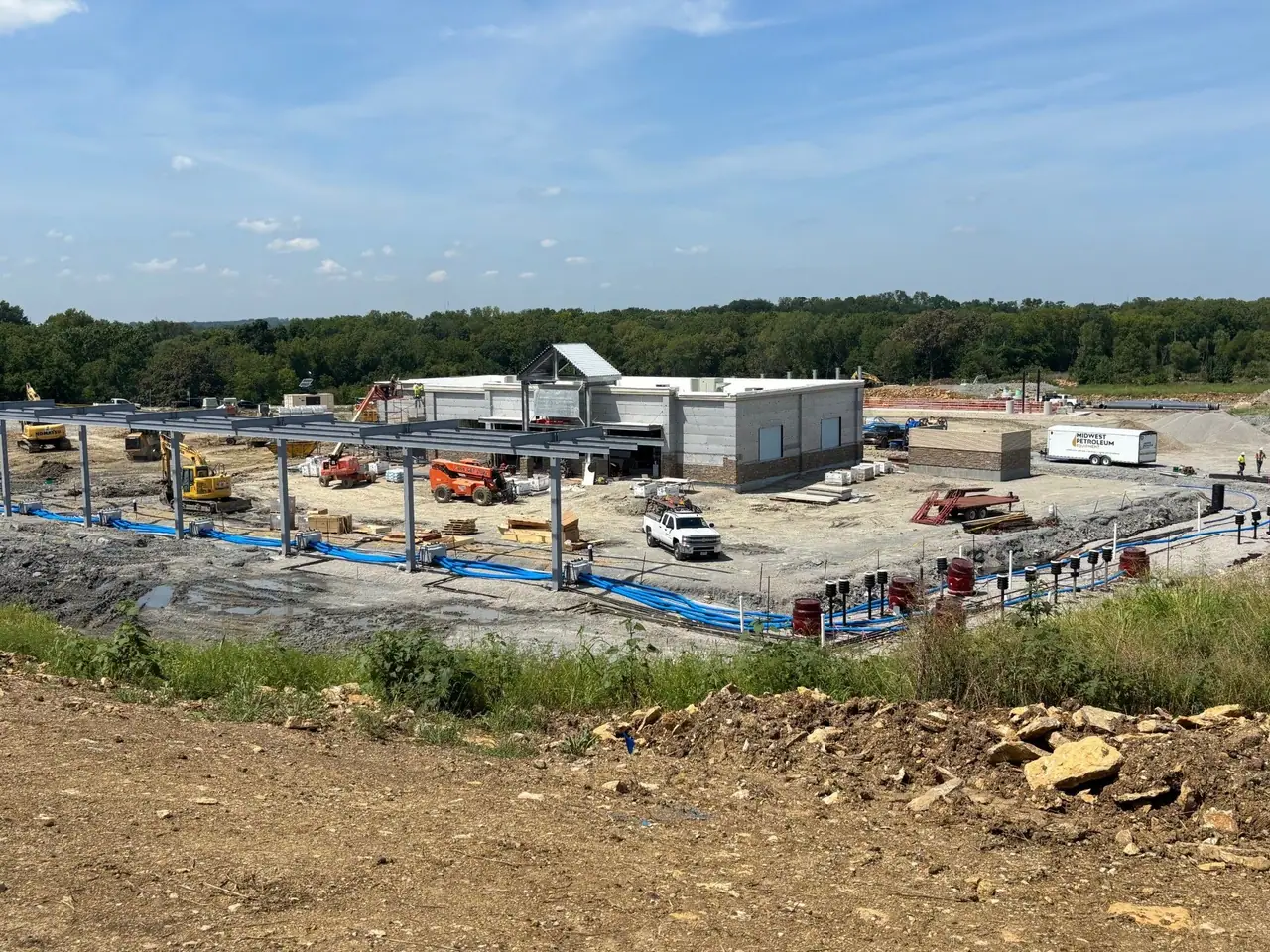 A travel plaza under construction, with its steel frame and equipment on a cleared site.