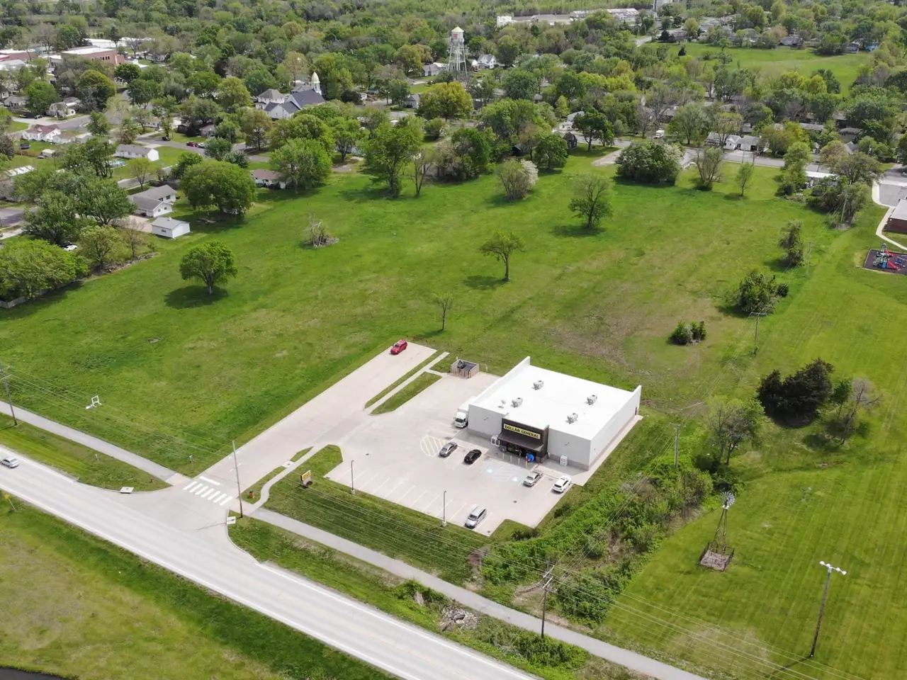 An open lot available for development along US-56, seen from the air.