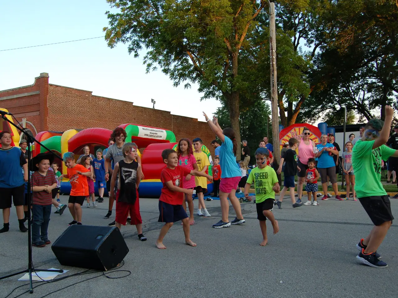 Children dance in the street during the Summer Kickoff block party in downtown Edgerton.
