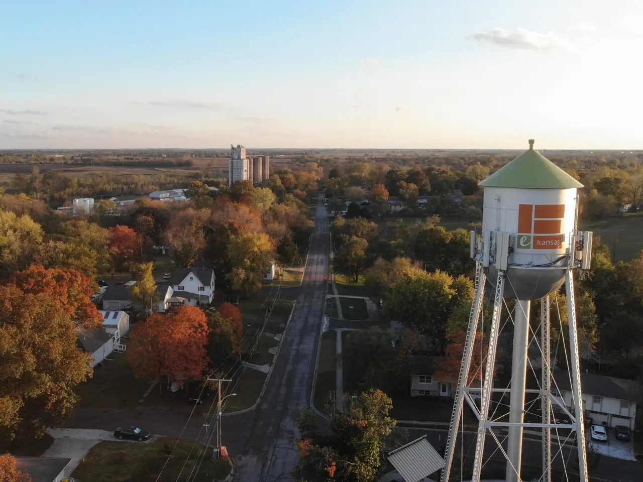 Edgerton's rooftops and orange autumn trees from the air, with the water tower at the right.