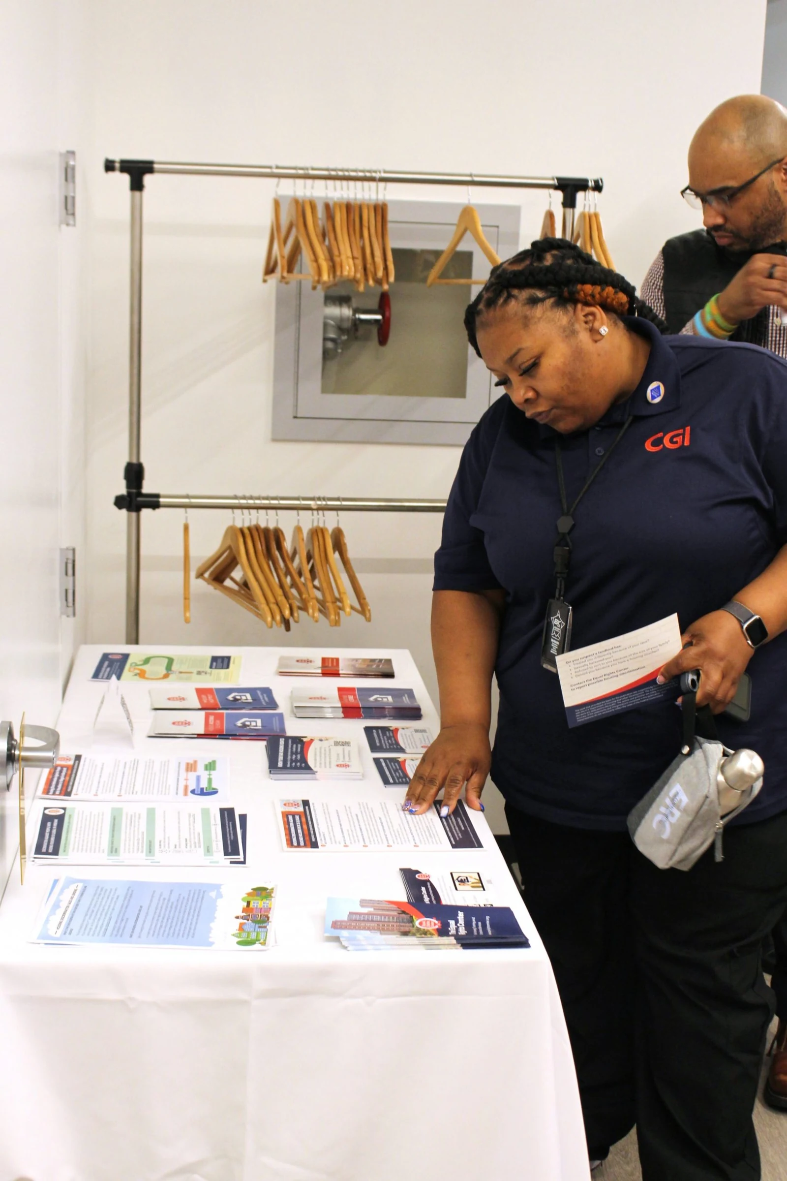 A guest looks through fair housing resources at ERC’s 2025 Annual Meeting.