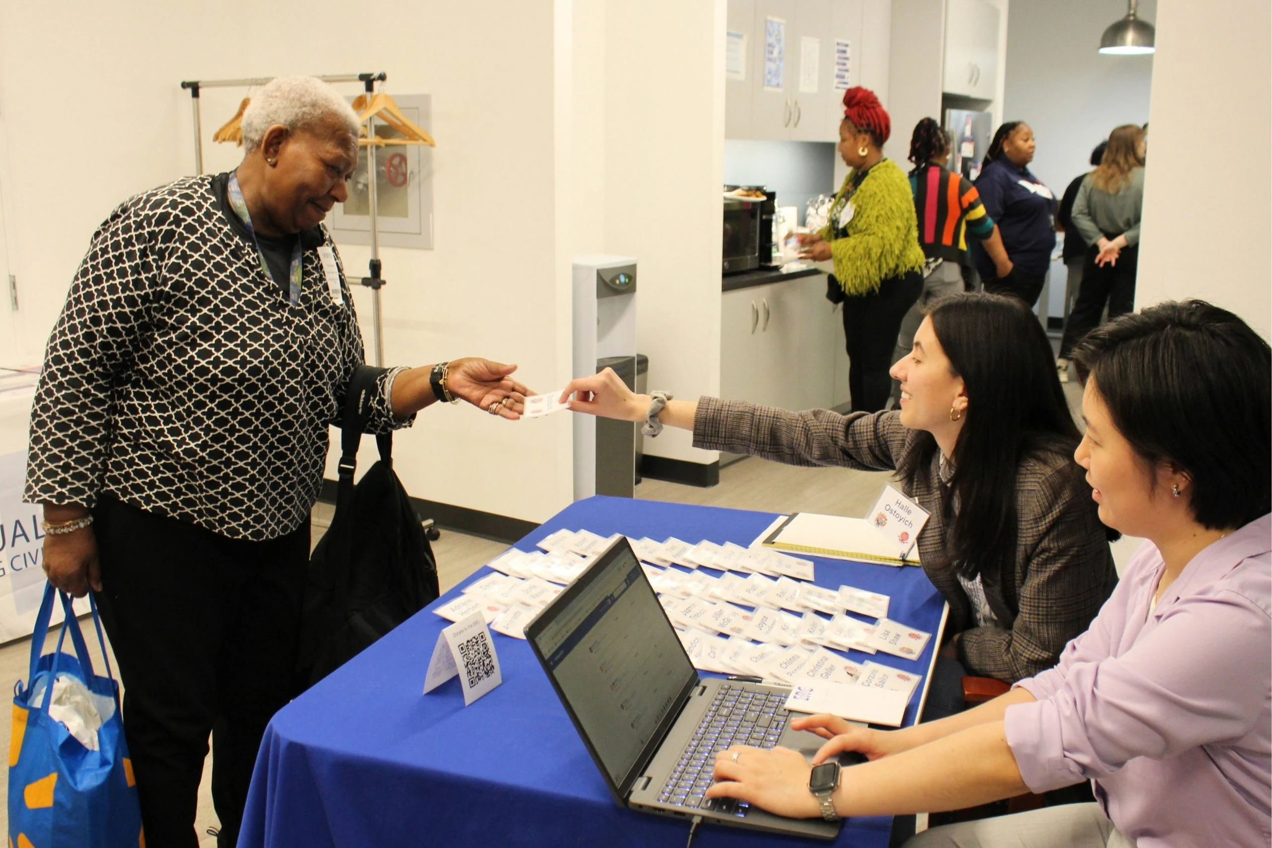 ERC staff welcome a guest with a name tag at the 2025 Annual Meeting.