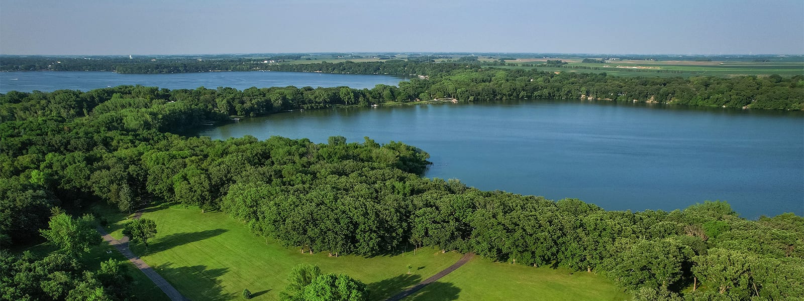 The Fairmont chain of lakes under open summer sky, water meeting the prairie horizon