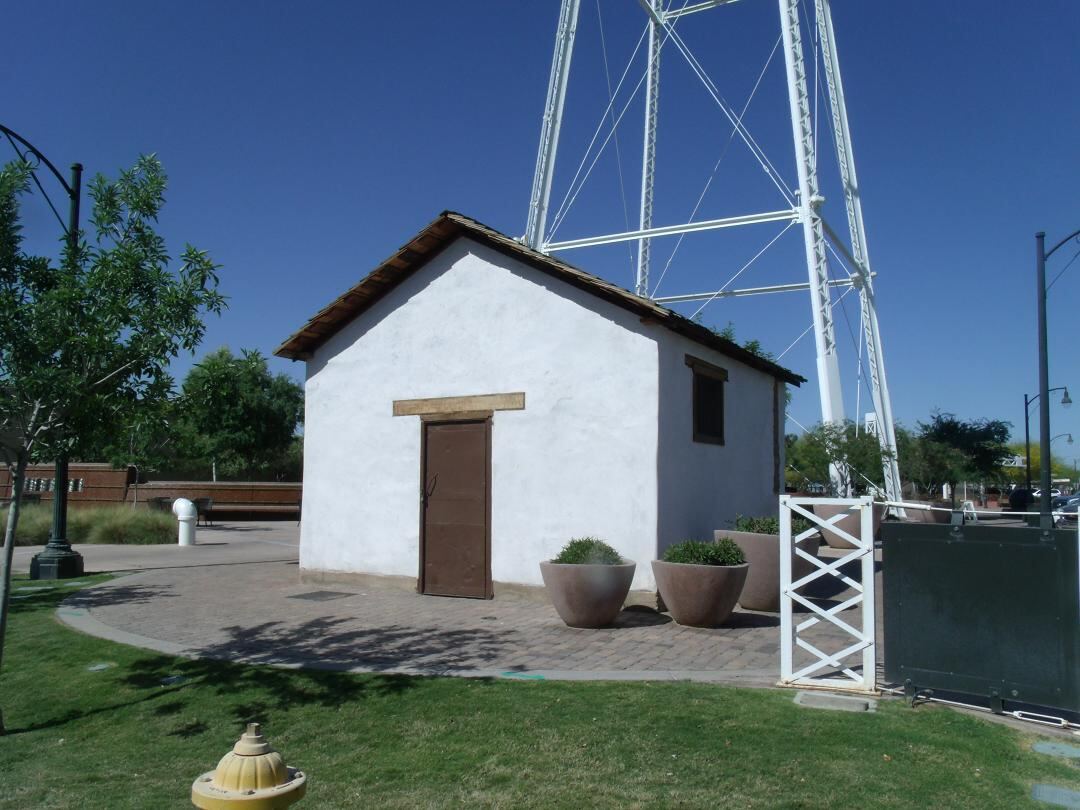 The small 1918 Gilberts jail house, a tiny historic building with a simple door and window.
