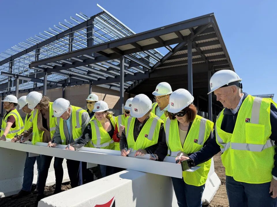 Community members at a Graham Park Exhibition Center beam-signing event.