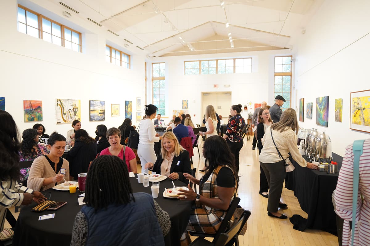 The gallery hall full of round tables and guests at the 50th Anniversary breakfast