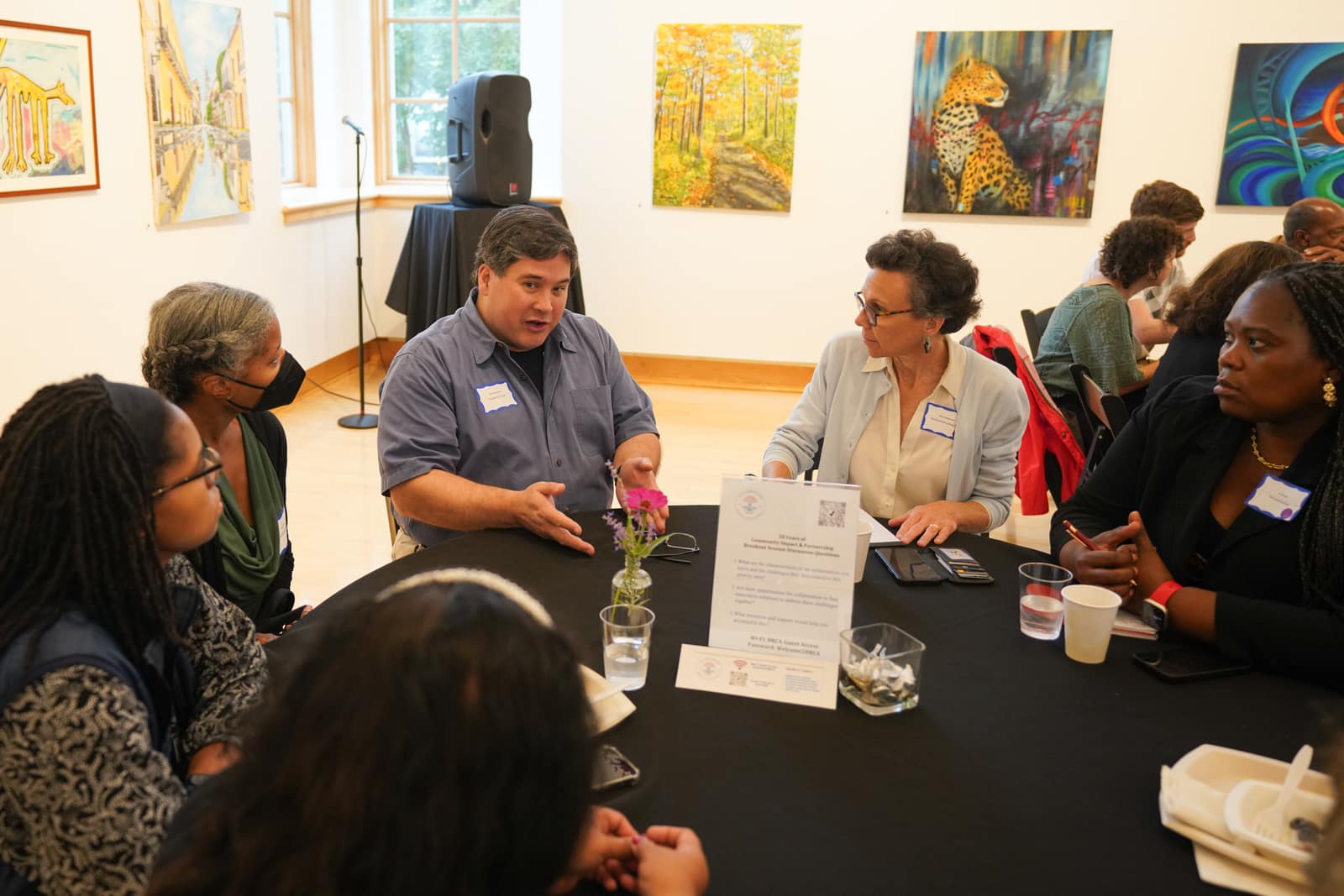 The Healthcare Workforce Education Pipeline breakout around a table in the art gallery