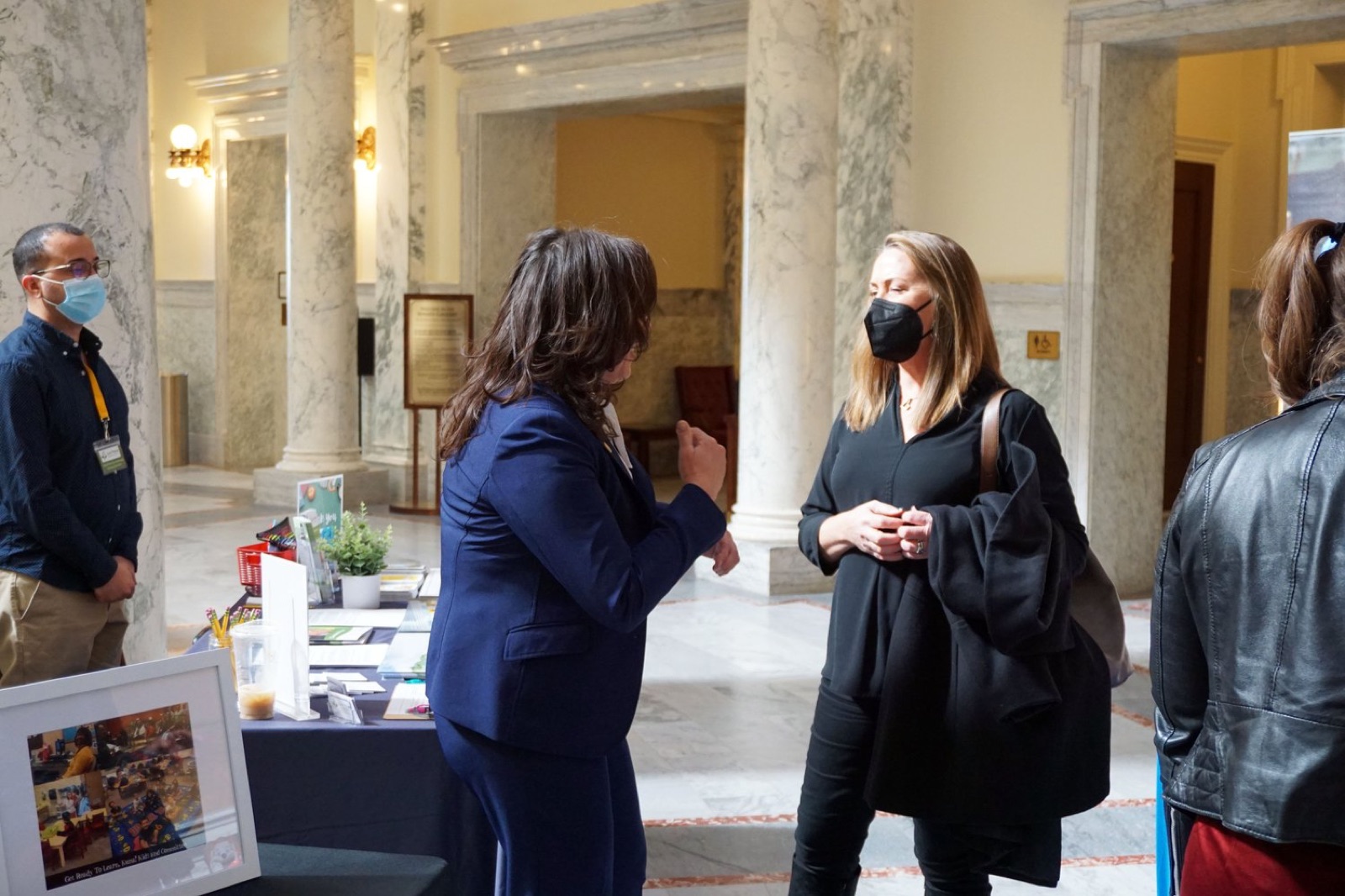 Idaho AEYC staff speaking with policymakers in the Idaho State Capitol during Early Learning Day