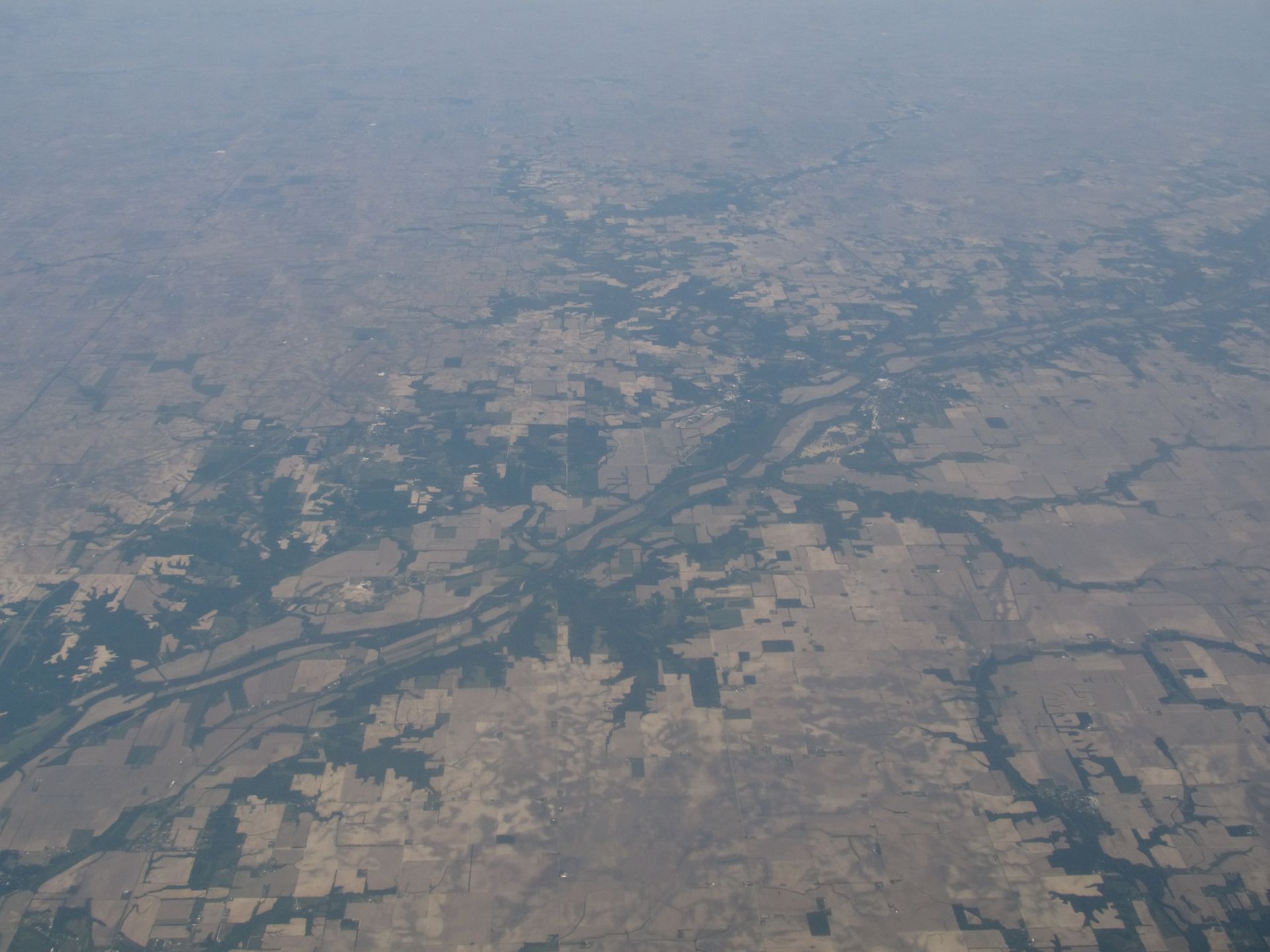 The Wabash River winding through wooded Indiana banks under a broad sky.