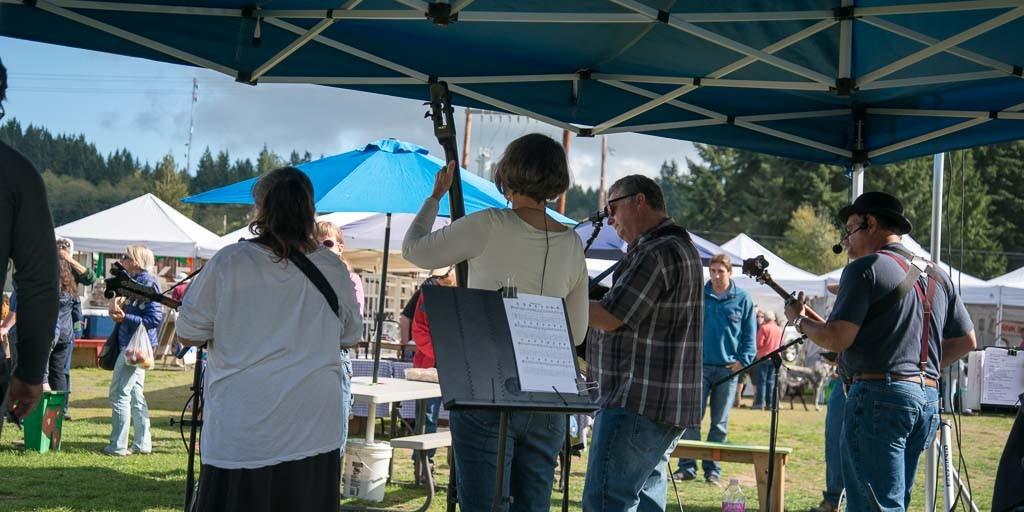 Musicians playing under the canopy at the Bayview Farmers Market
