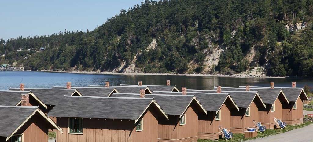The row of waterfront cedar cabins at Cama Beach State Park along the Saratoga Passage shore