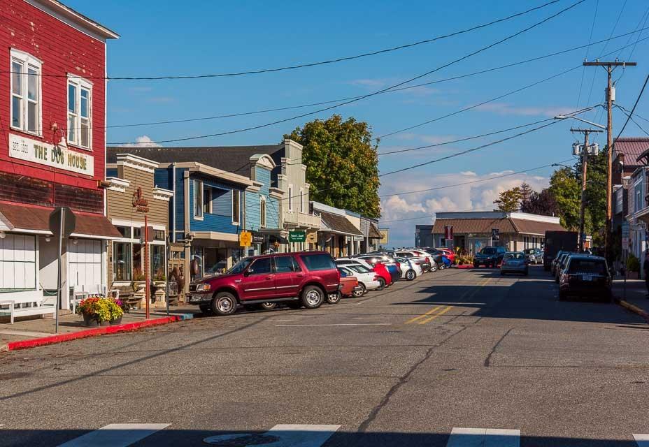 First Street in Langley: painted storefronts, the rainbow crosswalk, and Saratoga Passage at the end of the block