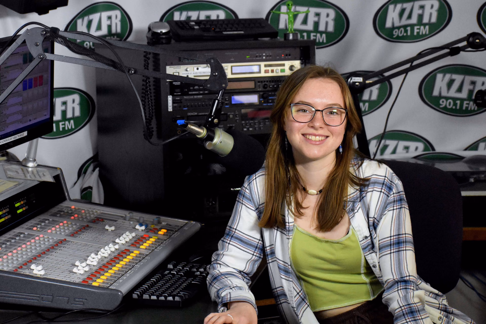 Ginger Nichols smiling at the microphone in the KZFR studio.