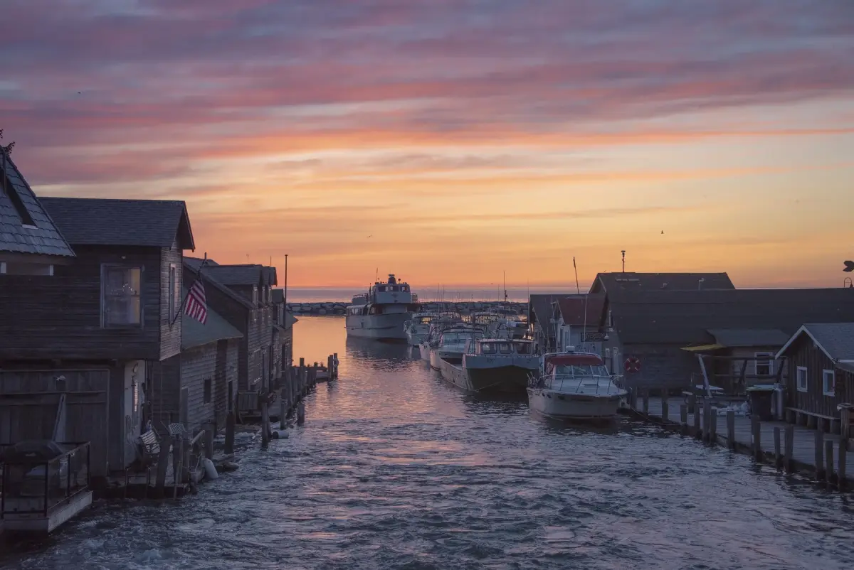 Fishtown's shanties and boats in warm evening light beside the Leland River