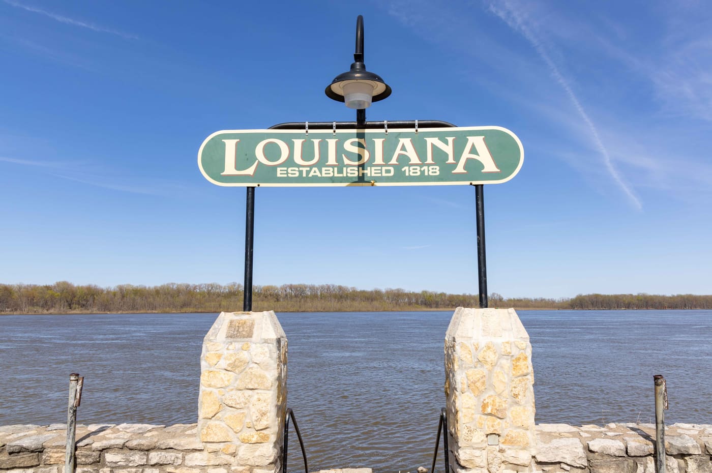 A riverfront monument sign reading Louisiana, Established 1818.