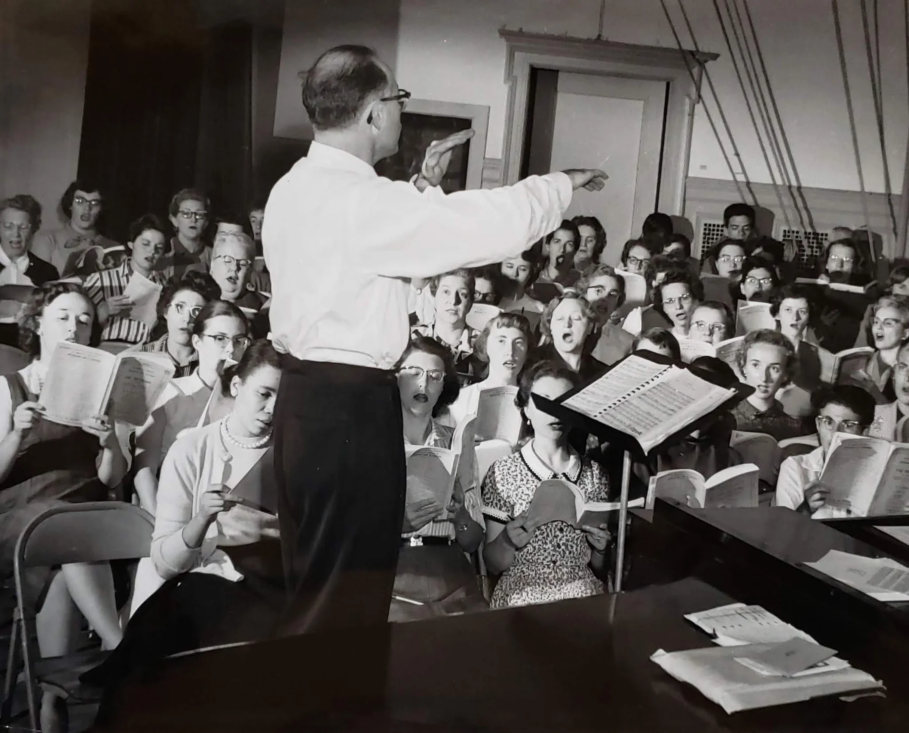 A black-and-white photograph of conductor David Randolph rehearsing the Masterwork Chorus.