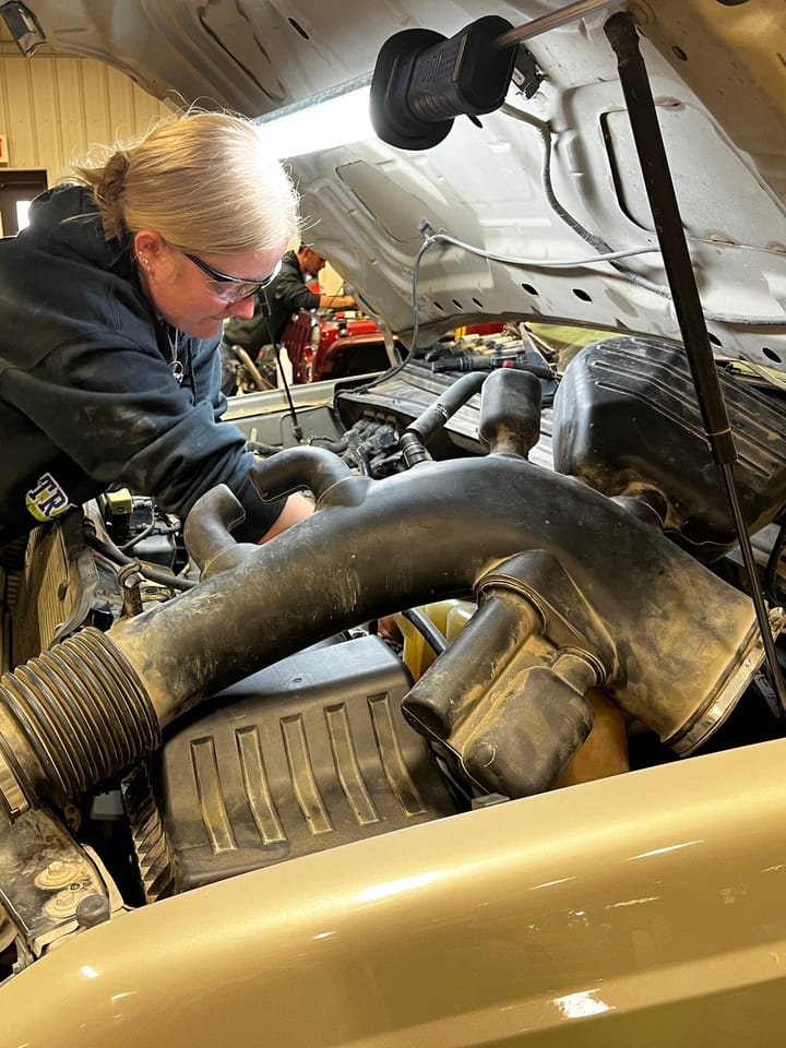 A student under the hood in the NCK Tech automotive shop