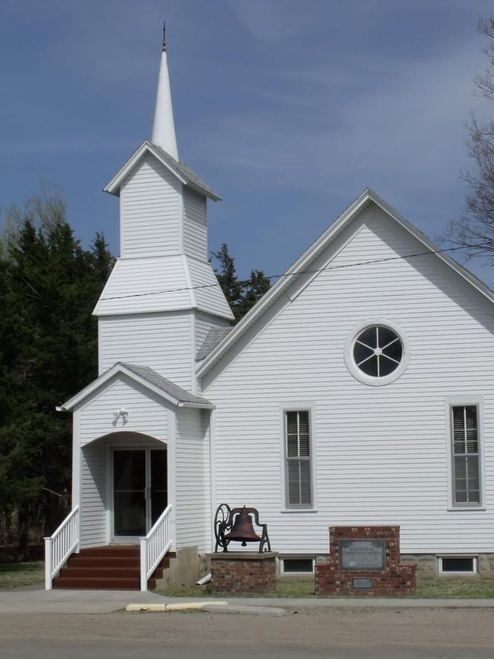 The white steepled church at Scottsville under a sky of small clouds
