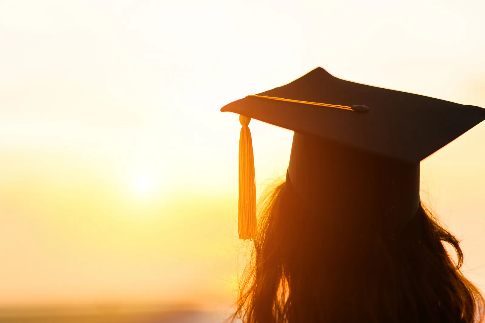 A graduate at sunset