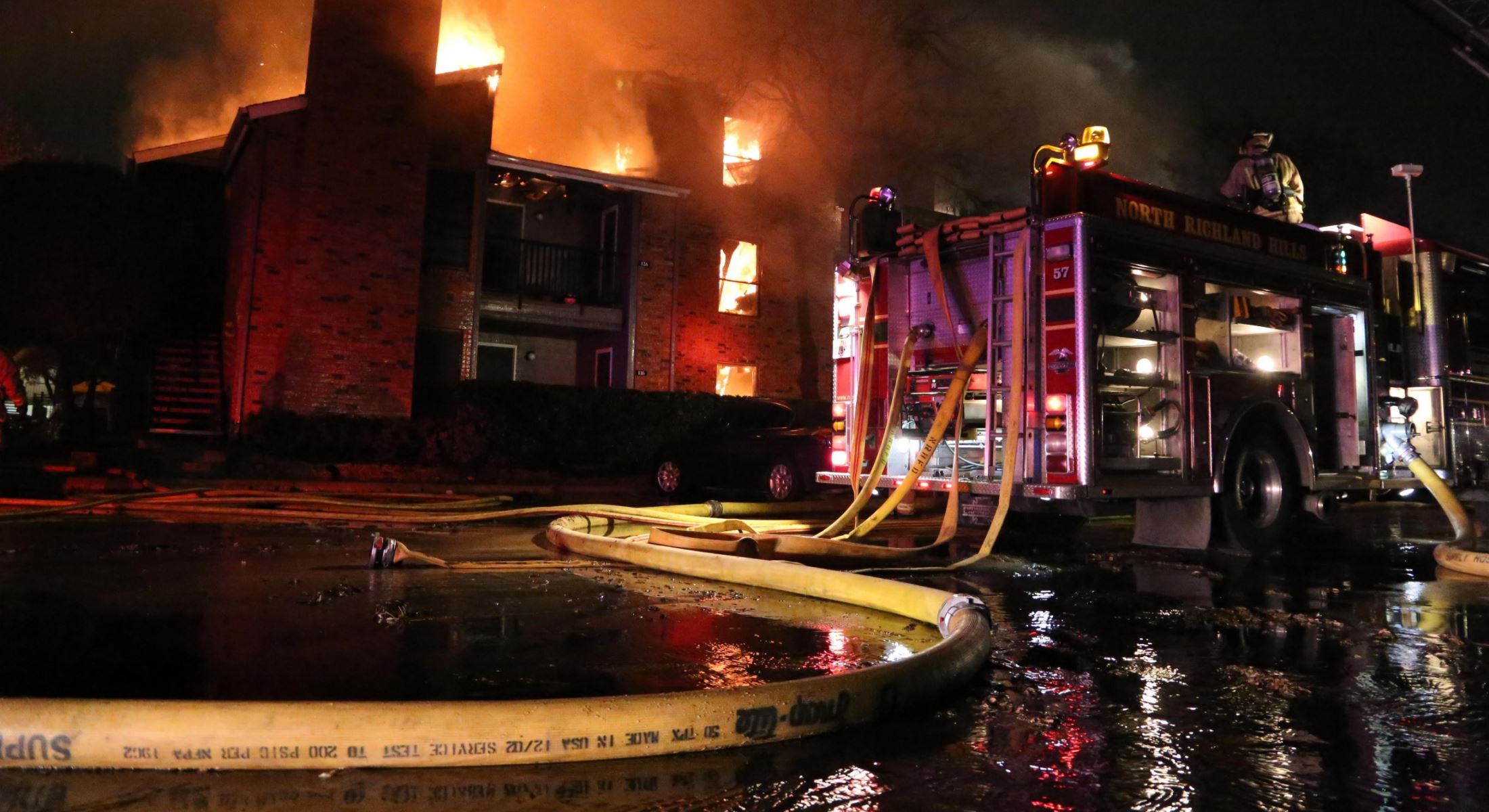 North Richland Hills fire apparatus responding to a structure fire at night