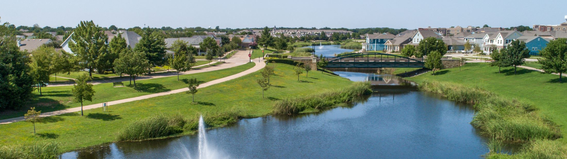 The Lakes at HomeTown in North Richland Hills, with a fountain, walking trail, and arched bridge